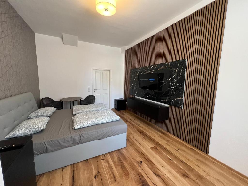 a bedroom with a bed and a tv on a wall at City Appartment 1 in Vienna