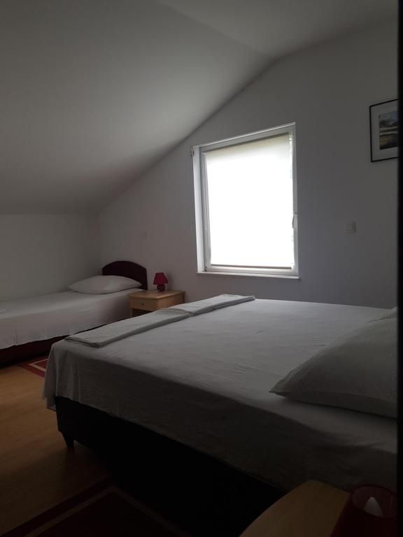 Postel nebo postele na pokoji v ubytování Apartments Damić