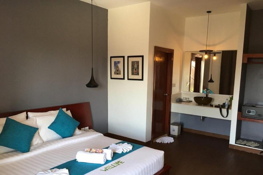 Postel nebo postele na pokoji v ubytování Siem Reap Tevi Residence