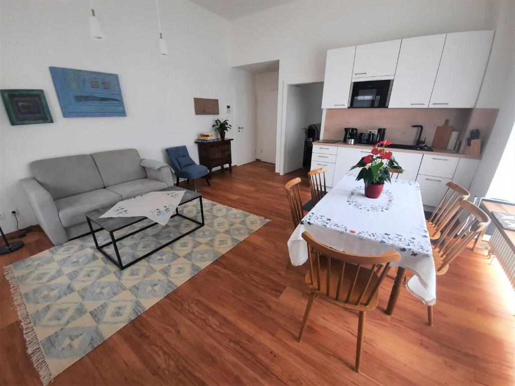 a kitchen and a living room with a table and chairs at Ferienwohnung Altstadthaus in Oberkirch