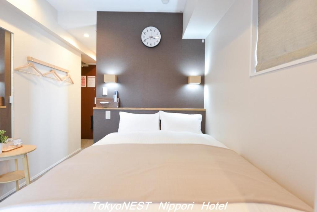 Postel nebo postele na pokoji v ubytování TokyoNEST Nippori