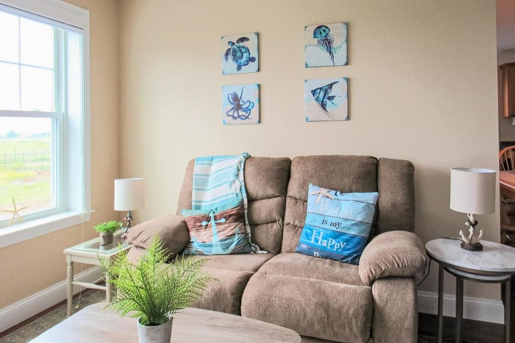 a living room with a couch with pillows on it at Sunset Pointe in Hampton