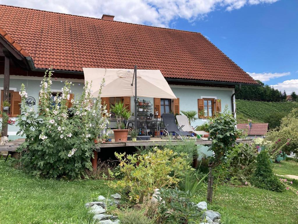 a house with a tent in the yard at Herzhof Lampert in Riegersburg