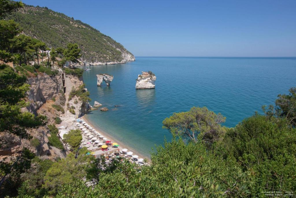 a view of a beach with a group of people at AH Premium Baia dei Faraglioni in Mattinata