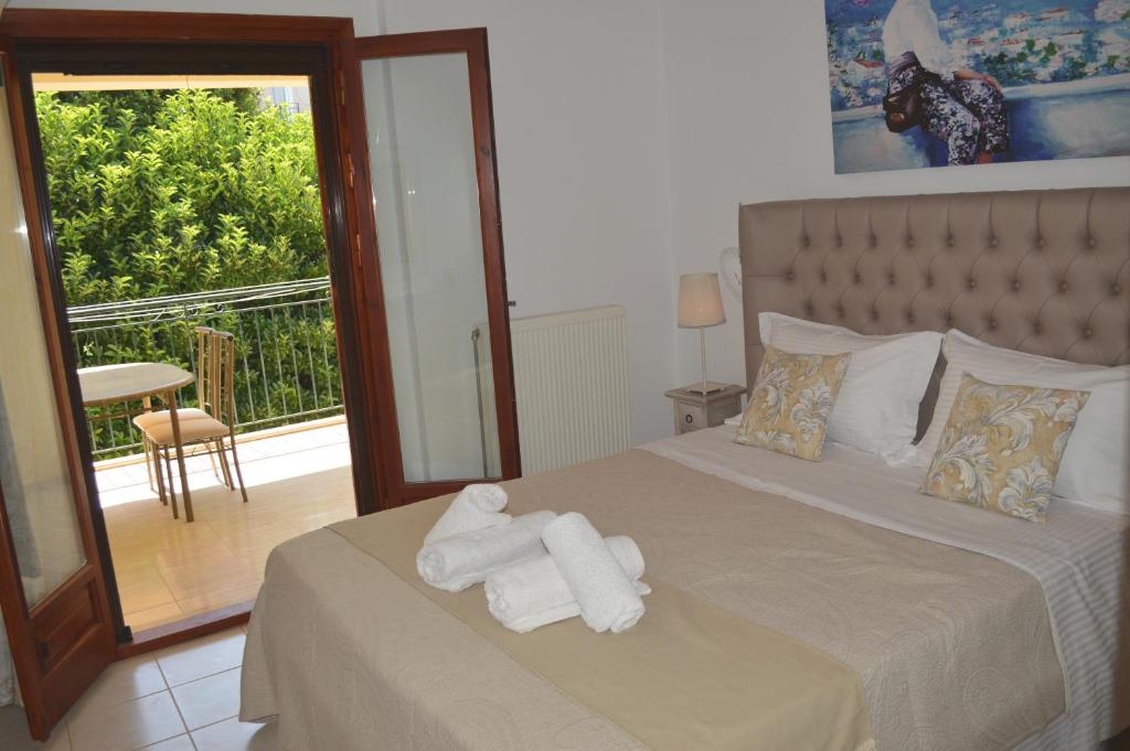 a bedroom with a bed with two folded towels on it at Best House,Appartments,Pylos Messinias in Pylos