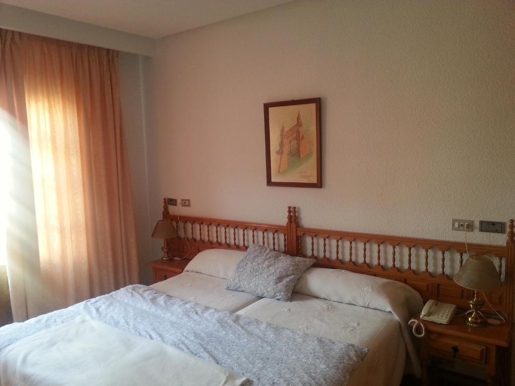 Postel nebo postele na pokoji v ubytování Hotel Gaudi