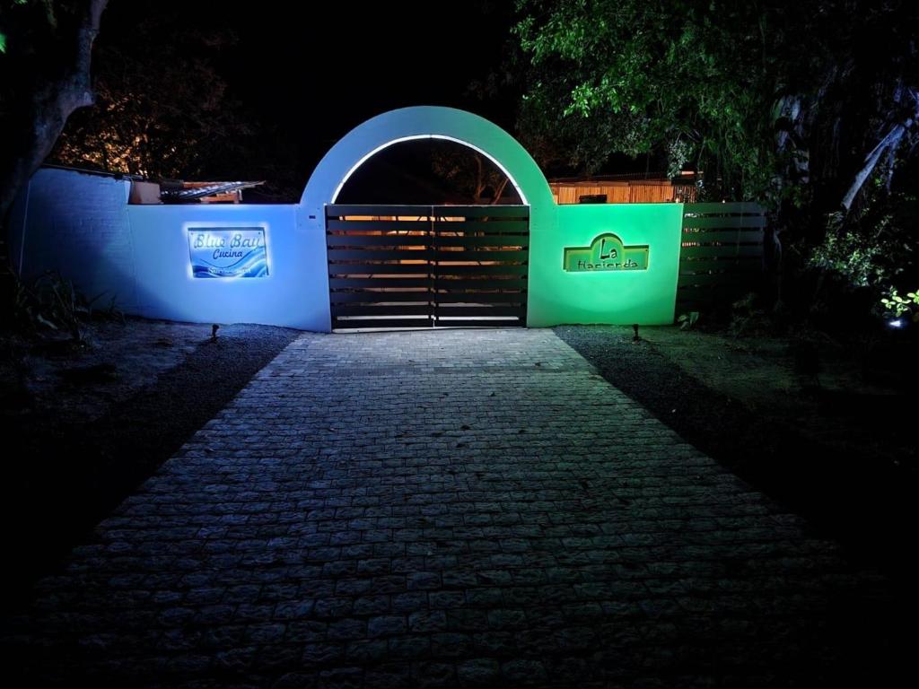 a gate to a house at night at La Hacienda in uMhlali