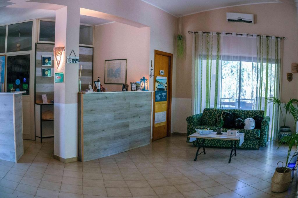 a living room with a couch and a table at Hotel L'Oleandro in Villasimius