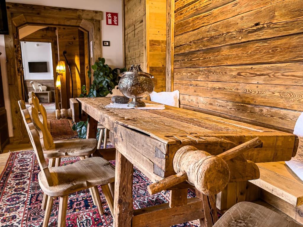 a dining room with a wooden table and chairs at Hotel da Beppe Sello in Cortina dʼAmpezzo