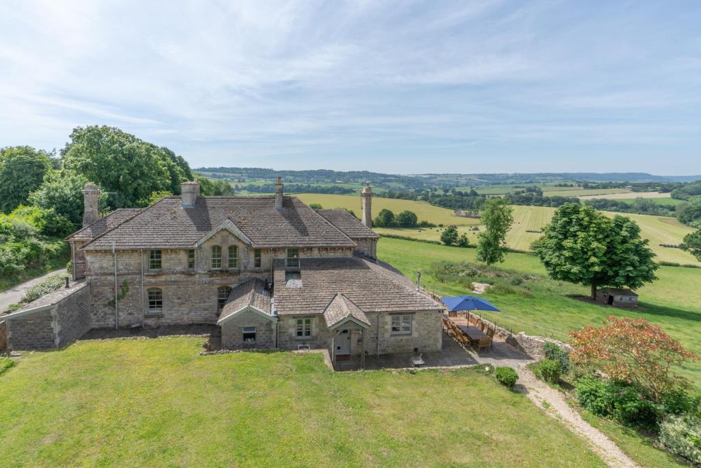 an aerial view of a large stone house on a hill at Ivy Cottage in Chippenham