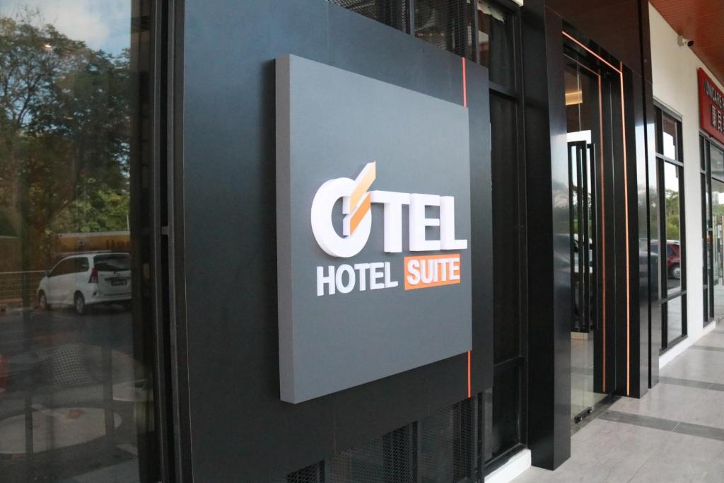 a sign for a hotel site on a building at OTEL Hotel Suite in Sibu