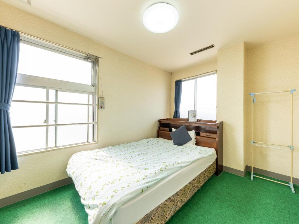 Postel nebo postele na pokoji v ubytování Tabist Business Hotel Chitose Kashiwazaki