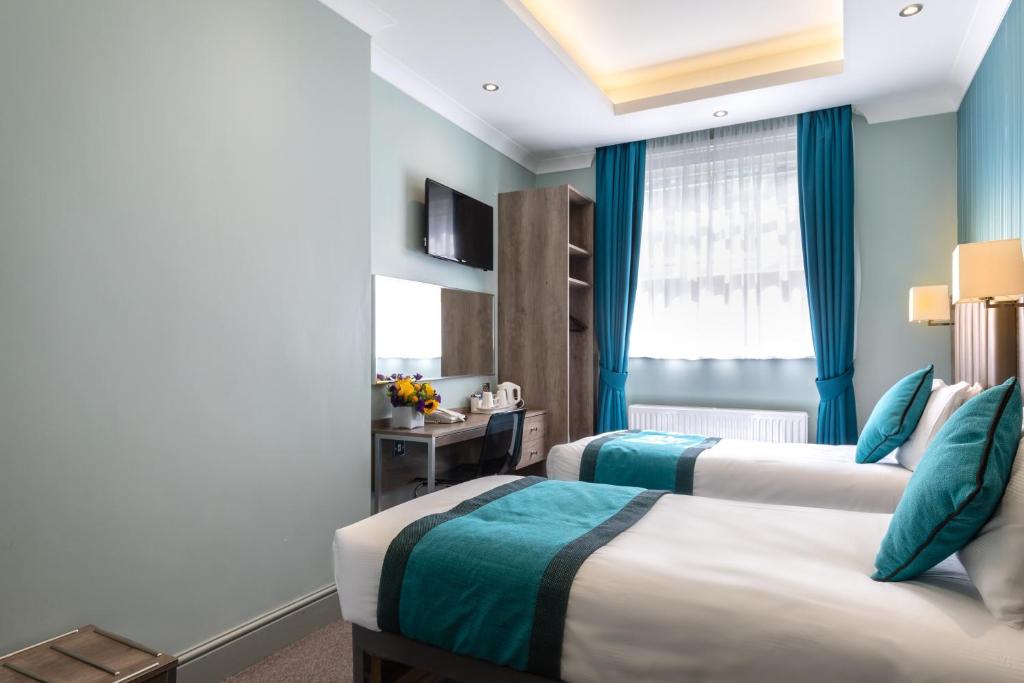 Postel nebo postele na pokoji v ubytování Sidney Hotel London-Victoria