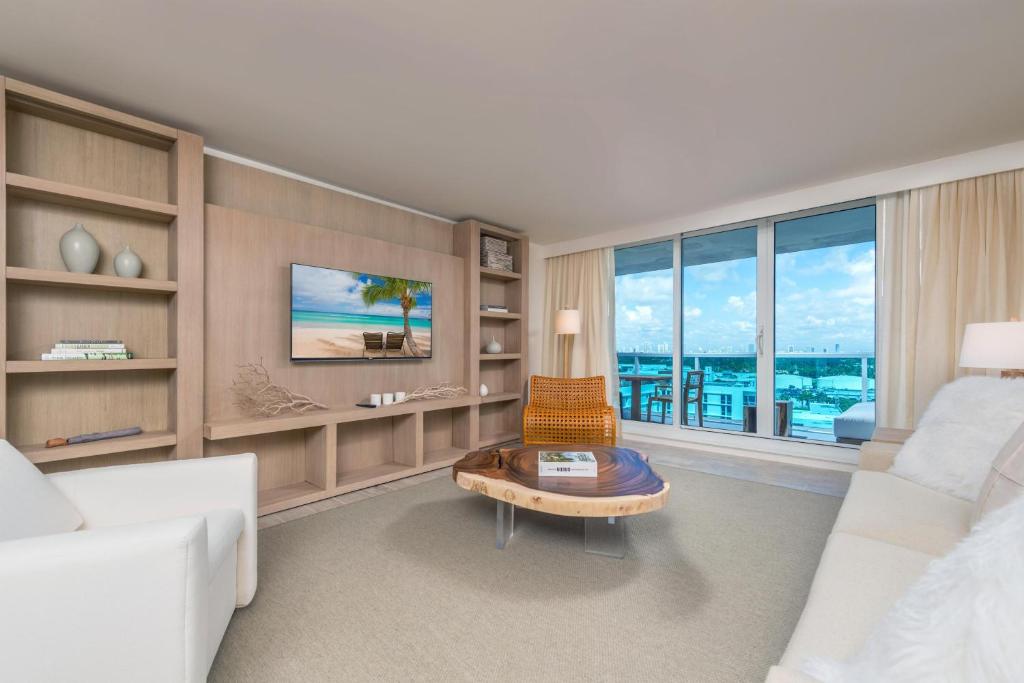 a living room with a white couch and a table at Luxurious Private Condo at 1 Hotel & Homes -1127 in Miami Beach