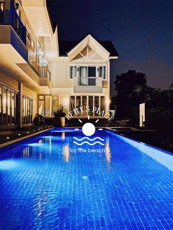 a swimming pool in front of a house at 4 Bedroom Beachfront House with Private Pool in Batangas in Nasugbu