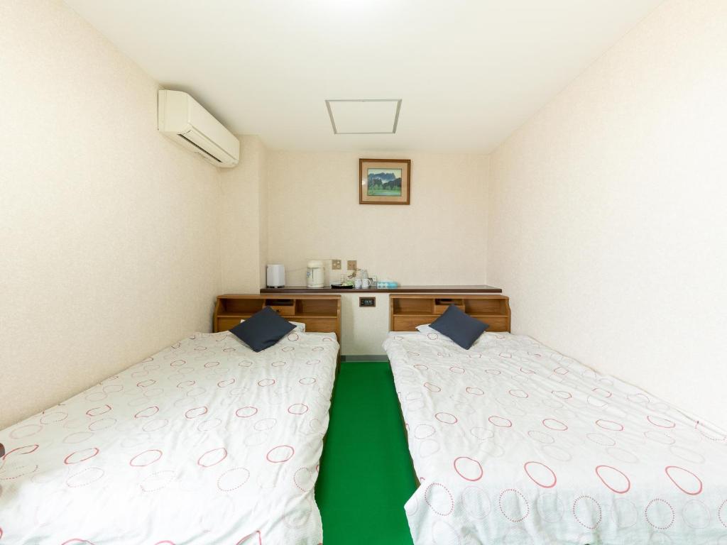 Postel nebo postele na pokoji v ubytování Tabist Business Hotel Chitose Kashiwazaki