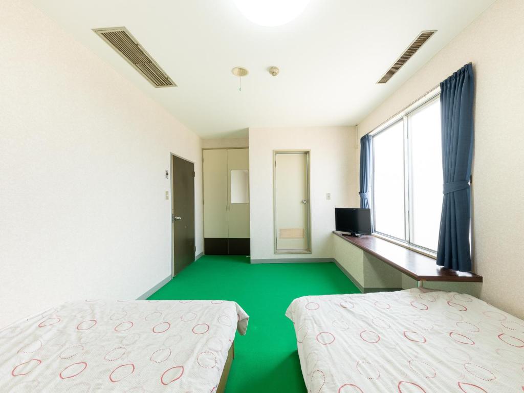 Postel nebo postele na pokoji v ubytování Tabist Business Hotel Chitose Kashiwazaki