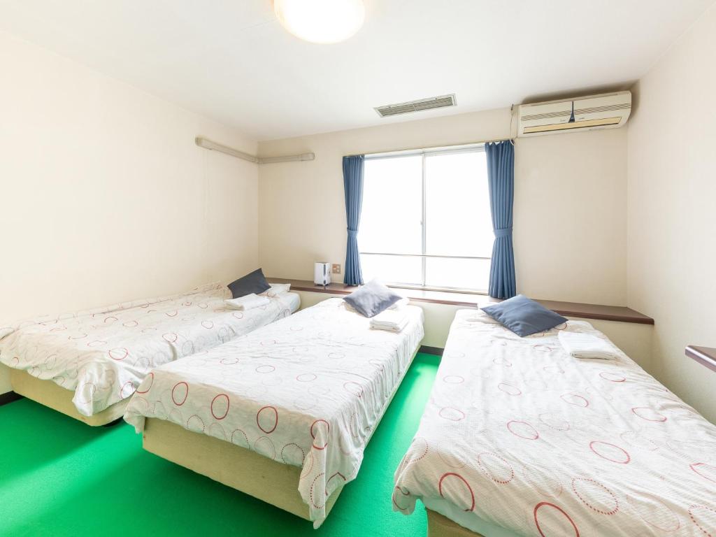 Postel nebo postele na pokoji v ubytování Tabist Business Hotel Chitose Kashiwazaki