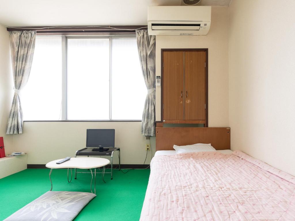 Postel nebo postele na pokoji v ubytování Tabist Business Hotel Chitose Kashiwazaki