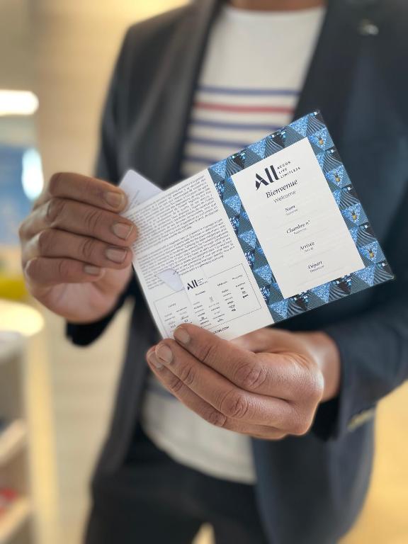 a person in a suit is holding a ticket at Novotel Monte-Carlo in Monte Carlo