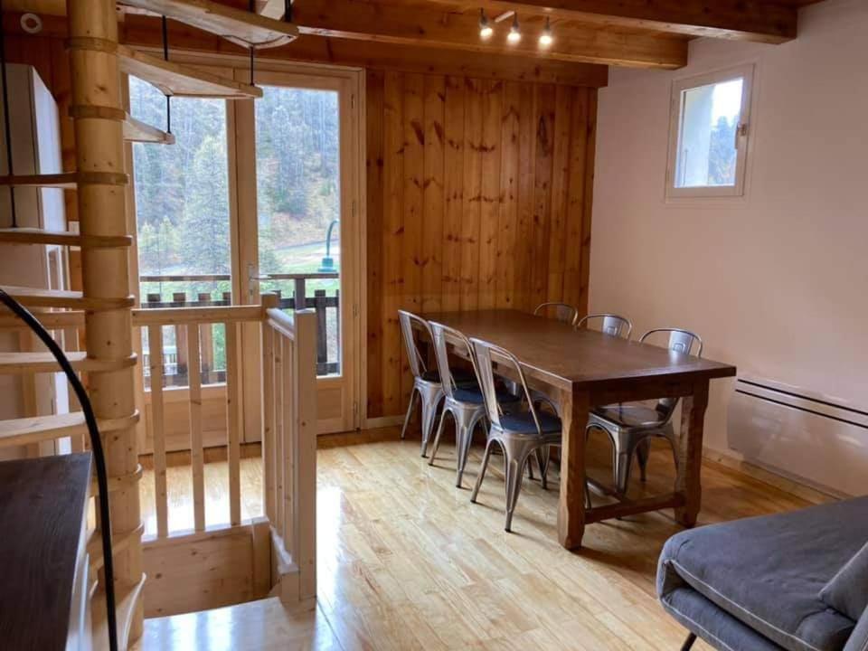 a dining room with a wooden table and chairs at Maglines in Vars