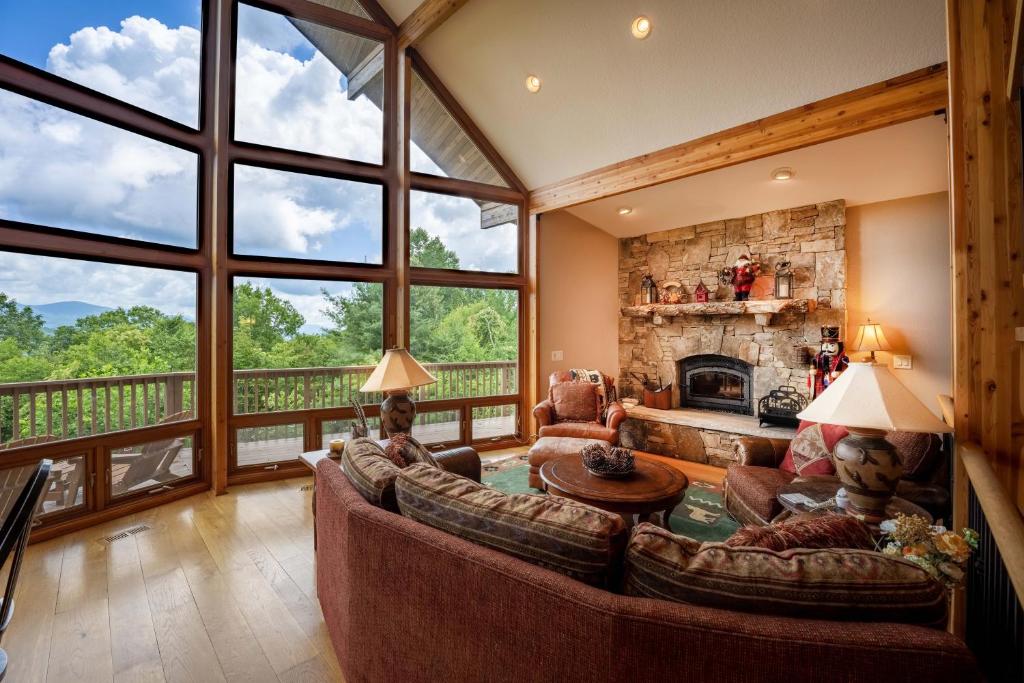 a living room with a couch and a fireplace at --Mountain Chalet Getaway with Breathtaking View Next to Tail of Dragon-- in Robbinsville