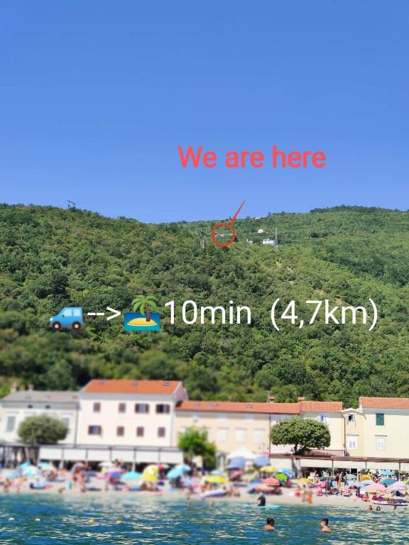 a picture of a beach with people in the water at Počitniška hiša Morski pogled in Mošćenička Draga