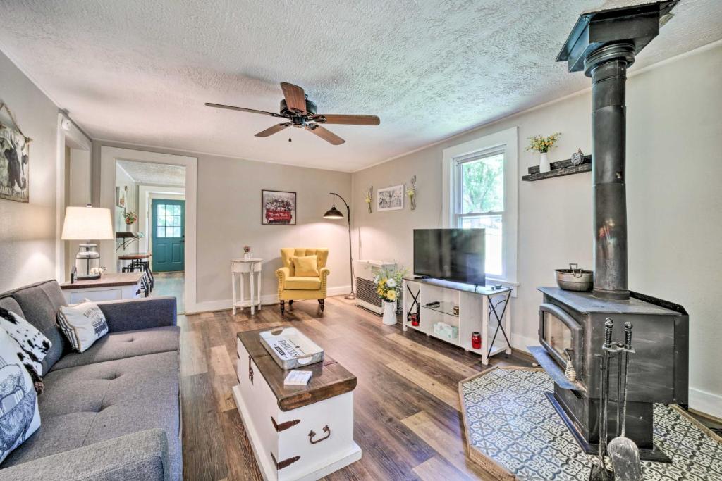 a living room with a couch and a stove at Charming Waynesville Cottage Less Than 2 Mi to Main St in Waynesville