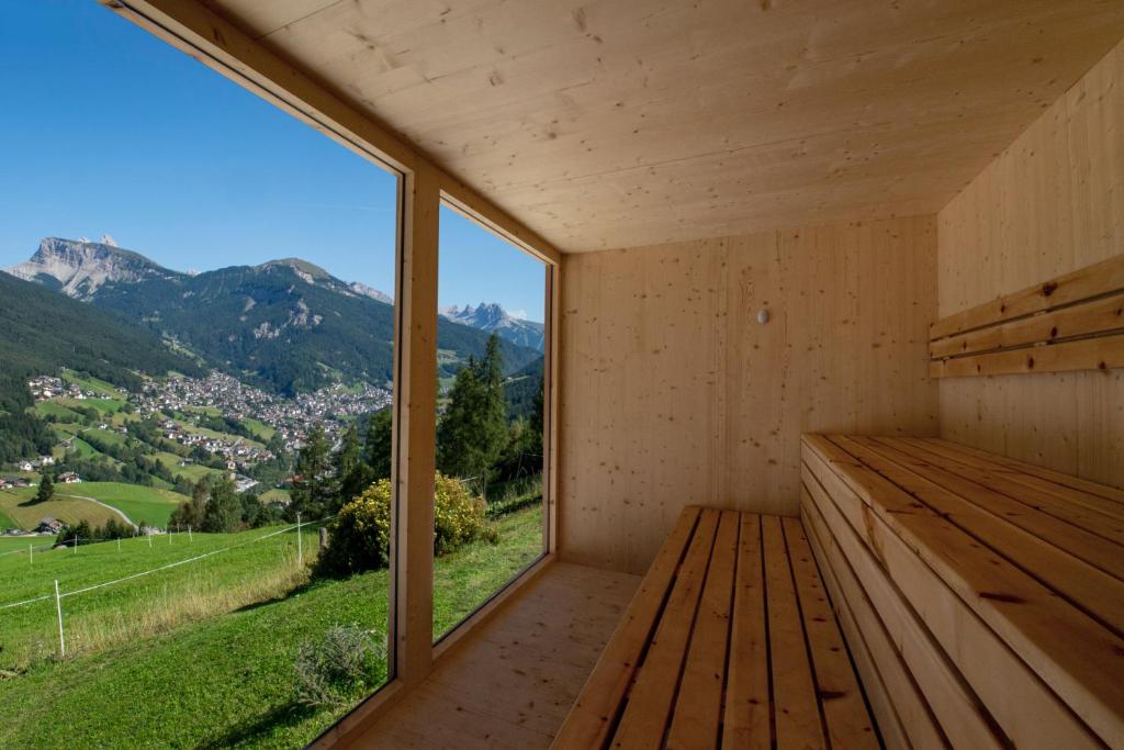 a room with a bench and a large window at Chalet Alpina in Ortisei