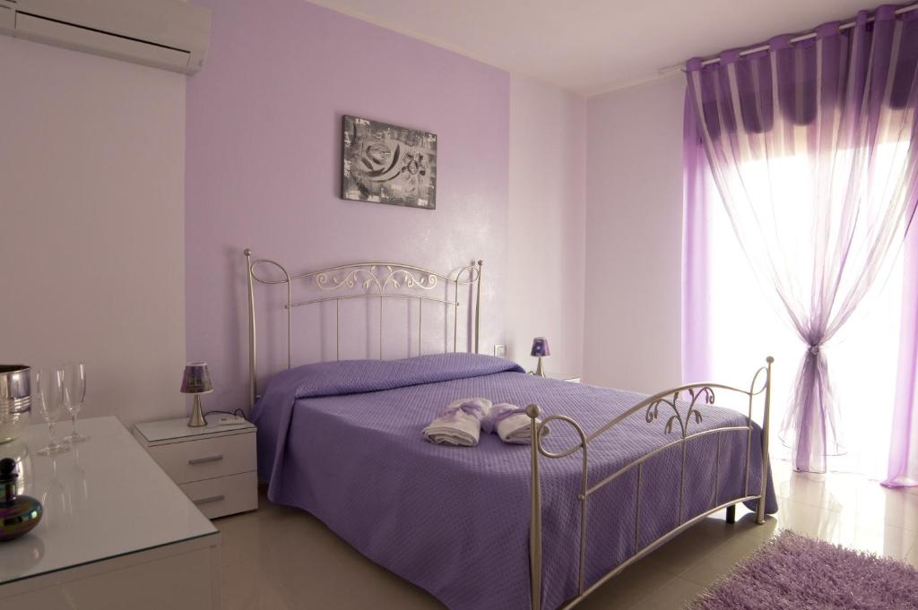 Een bed of bedden in een kamer bij Orchidea Casa Vacanze