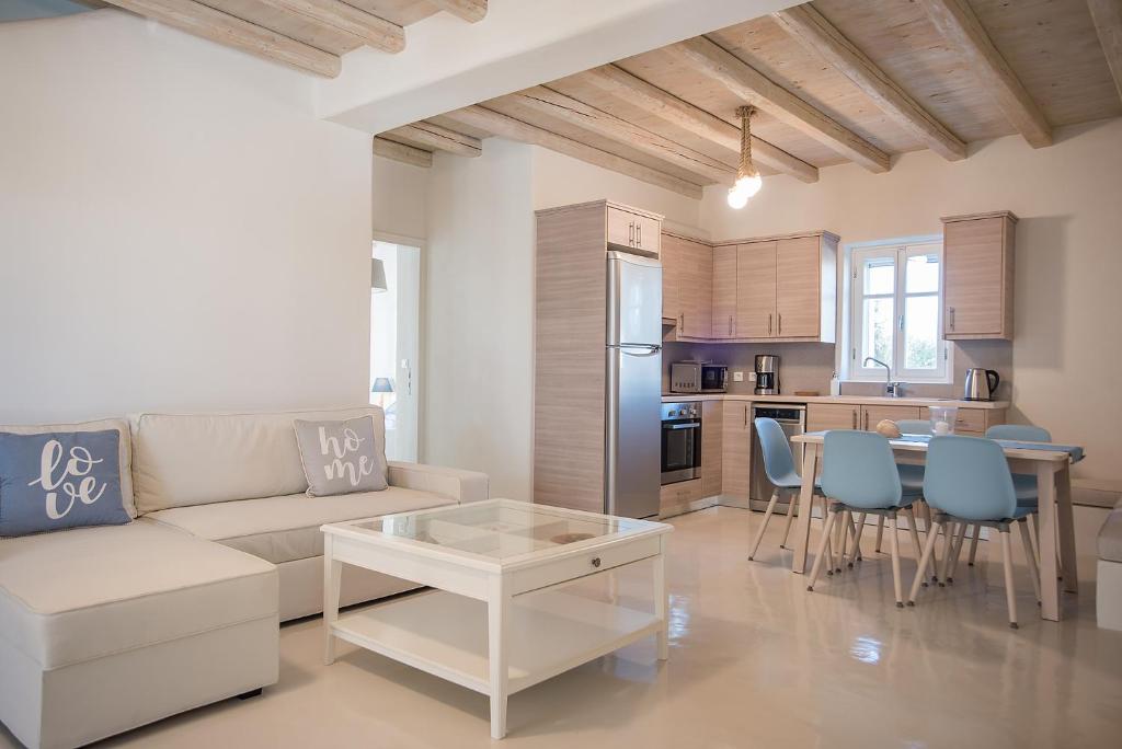 a living room with a couch and a table at Anemos Sails 4 in Pounda