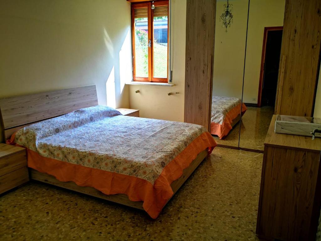 a bedroom with two beds and a window at Villa Grazia in Serina