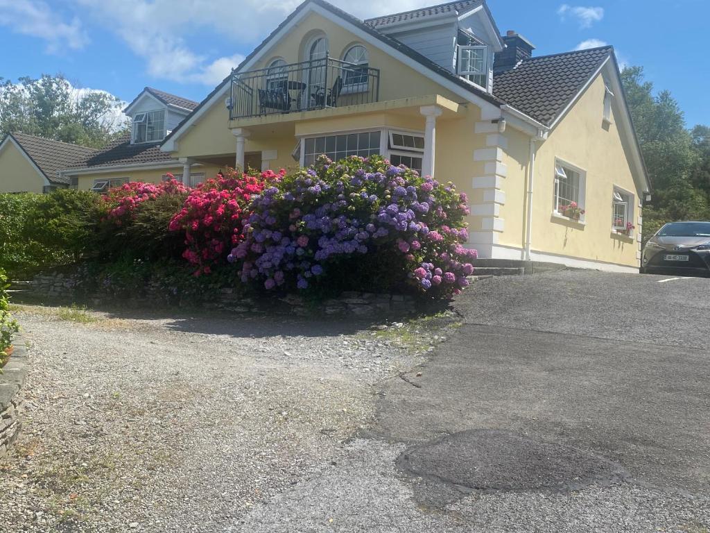 a house with flowers in front of it at Oakfield in Kenmare