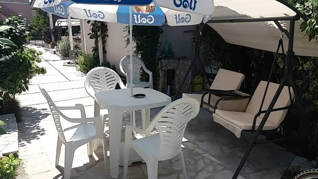 a table and chairs under an umbrella on a patio at Apartment’s Maric - Zelenika,Herceg Novi in Zelenika