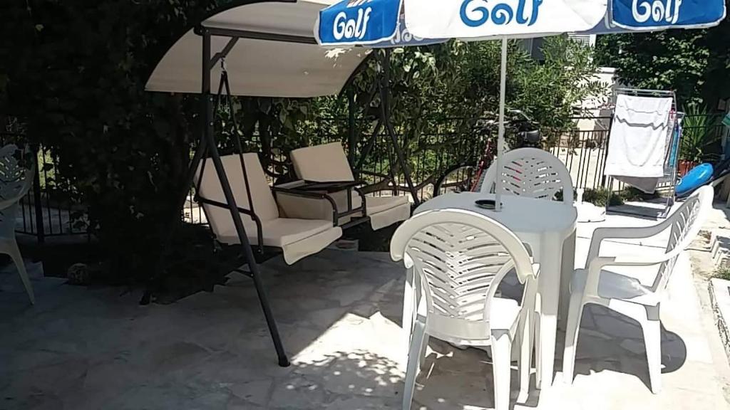a table and chairs under an umbrella on a patio at Apartment’s Maric - Zelenika,Herceg Novi in Zelenika