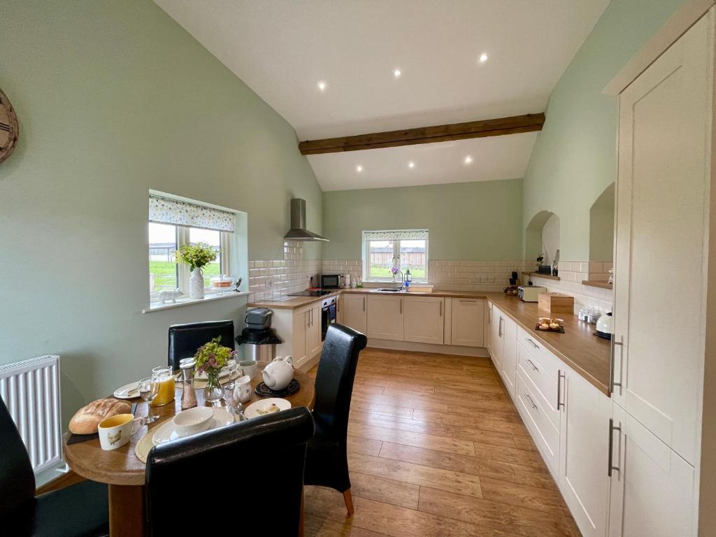 a large kitchen with a table and a dining room at Fieldsview in Wrexham
