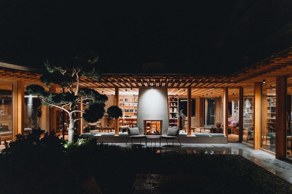 a house with a fireplace in a courtyard at night at Sensoria Dolomites in Siusi