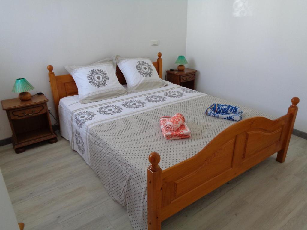 1 dormitorio con 1 cama de madera y 2 mesitas de noche en Le gite de la gare, en Challans