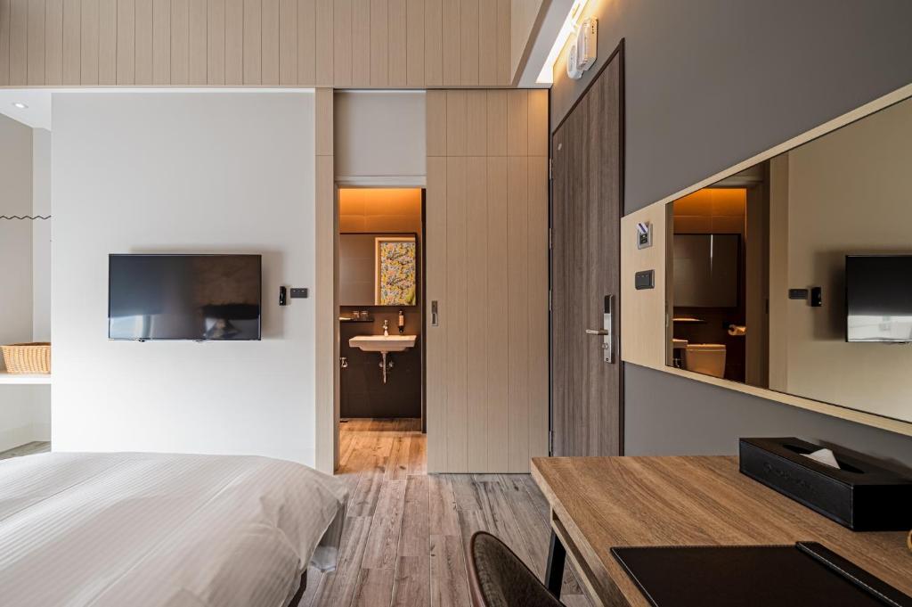 Postel nebo postele na pokoji v ubytování 森行旅 Mori Hotel -台南安平老街