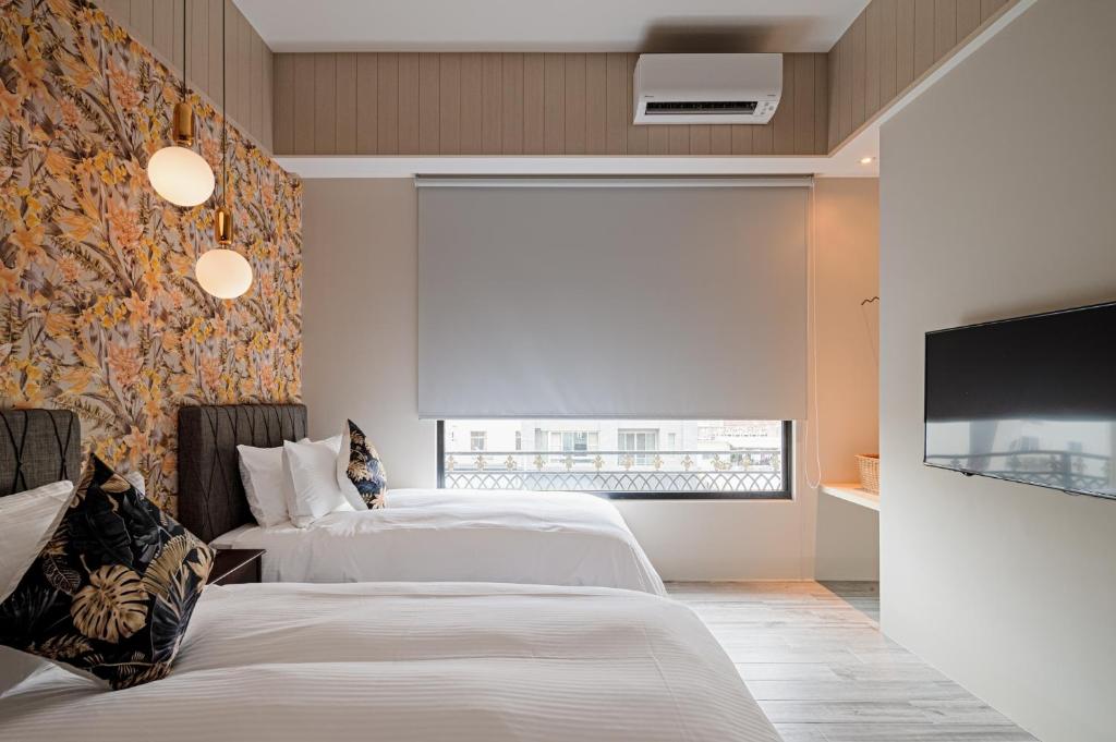 Postel nebo postele na pokoji v ubytování 森行旅 Mori Hotel -台南安平老街