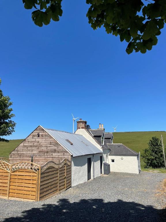 a large building with a garage in front of it at Bramble Cottage in Turriff
