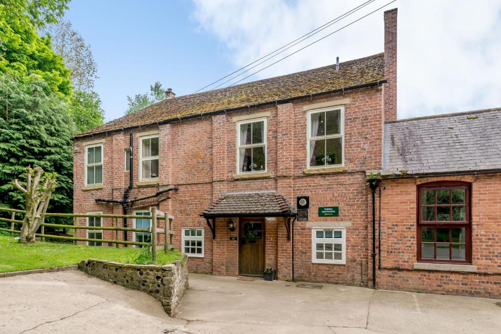 an old red brick building with a door at Shuttle Apartment in Northallerton