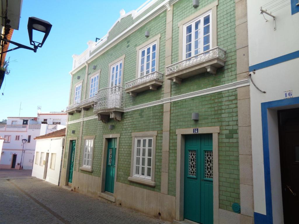 a green brick building with white windows and green doors at AL-Odeceixe Verde in Odeceixe