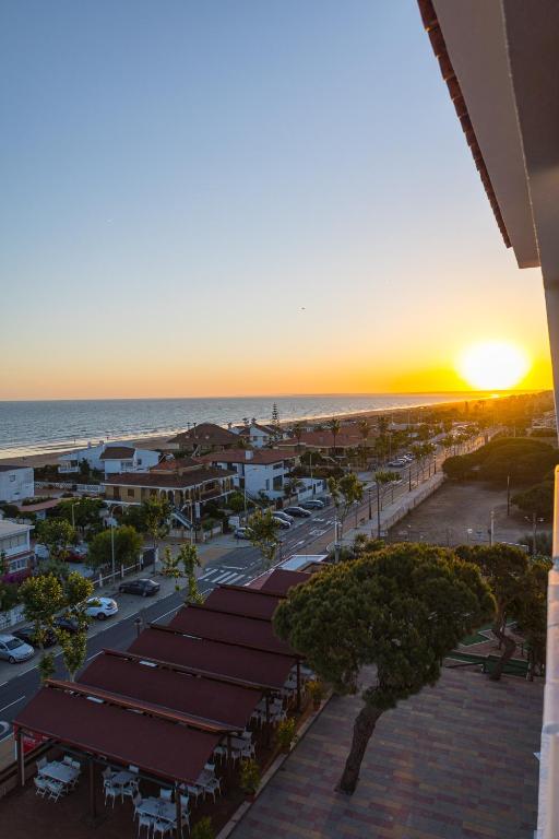 an aerial view of a city with a sunset at Pato Rojo in Punta Umbría