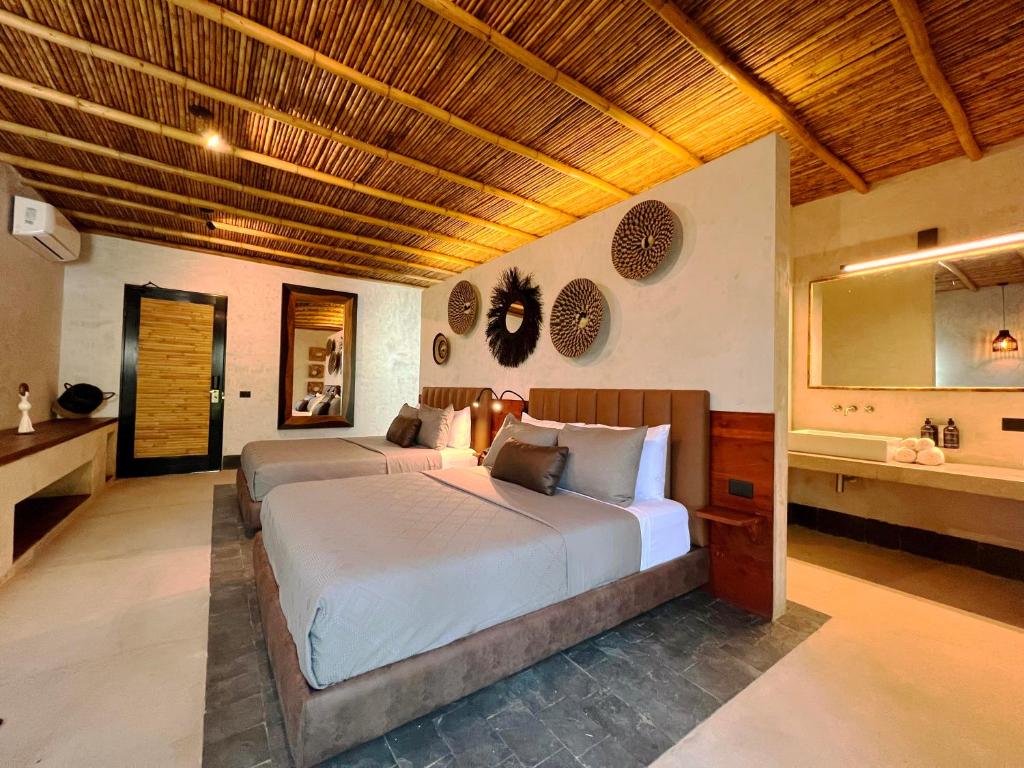 Postel nebo postele na pokoji v ubytování Gran Tamoanchan