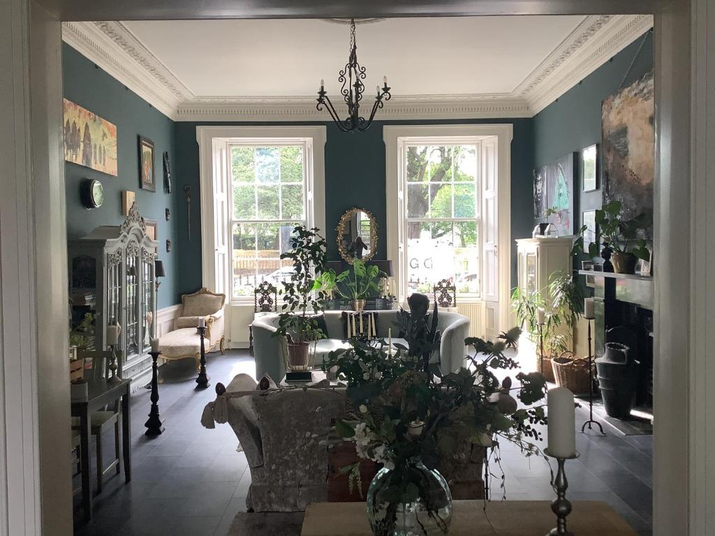 a living room filled with lots of plants at A Room in the City - West in Edinburgh