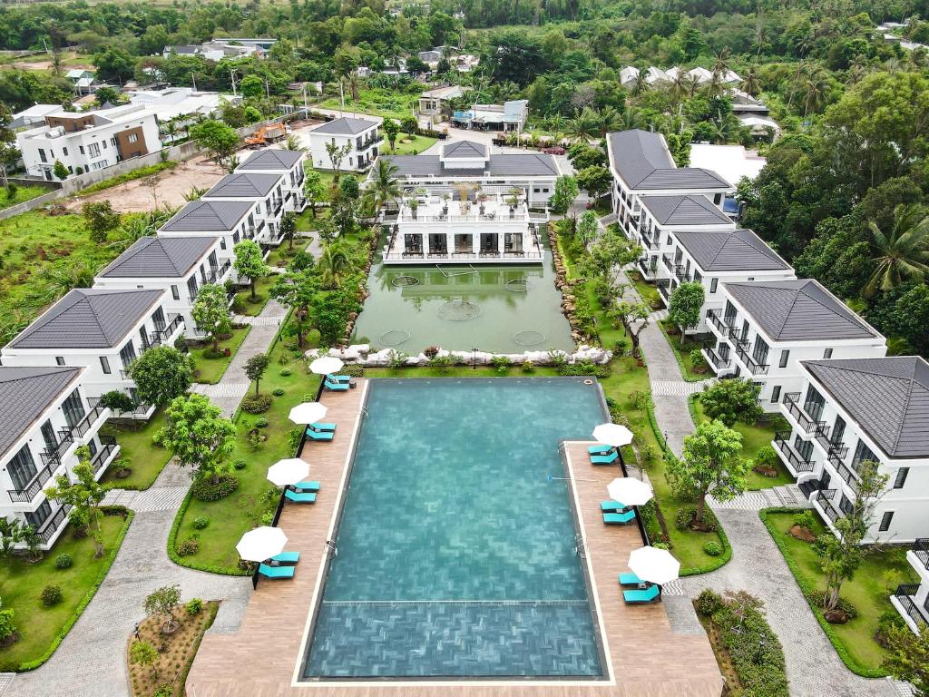 an aerial view of a resort pool with umbrellas at DAD Resort Phú Quốc in Phú Quốc