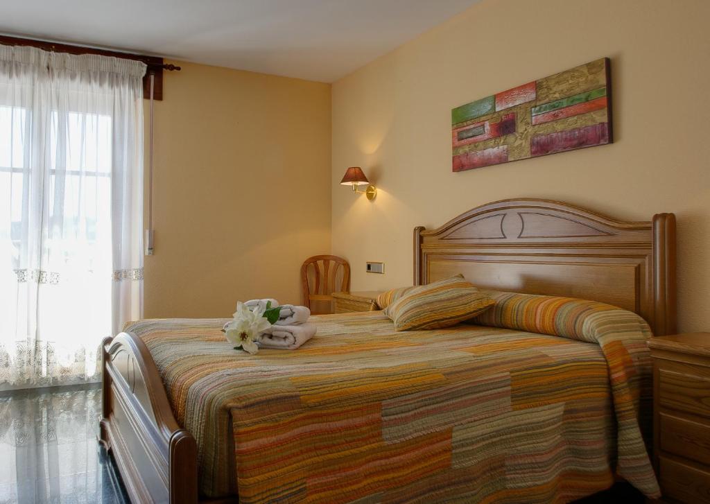 En eller flere senge i et værelse på Hostal Casa Ramón