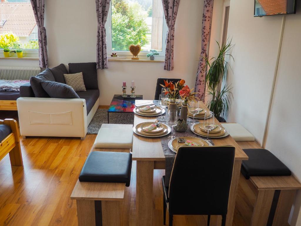 a living room with a table and a dining room at Ottl's Appartement O2 in Sankt Lorenzen ob Murau