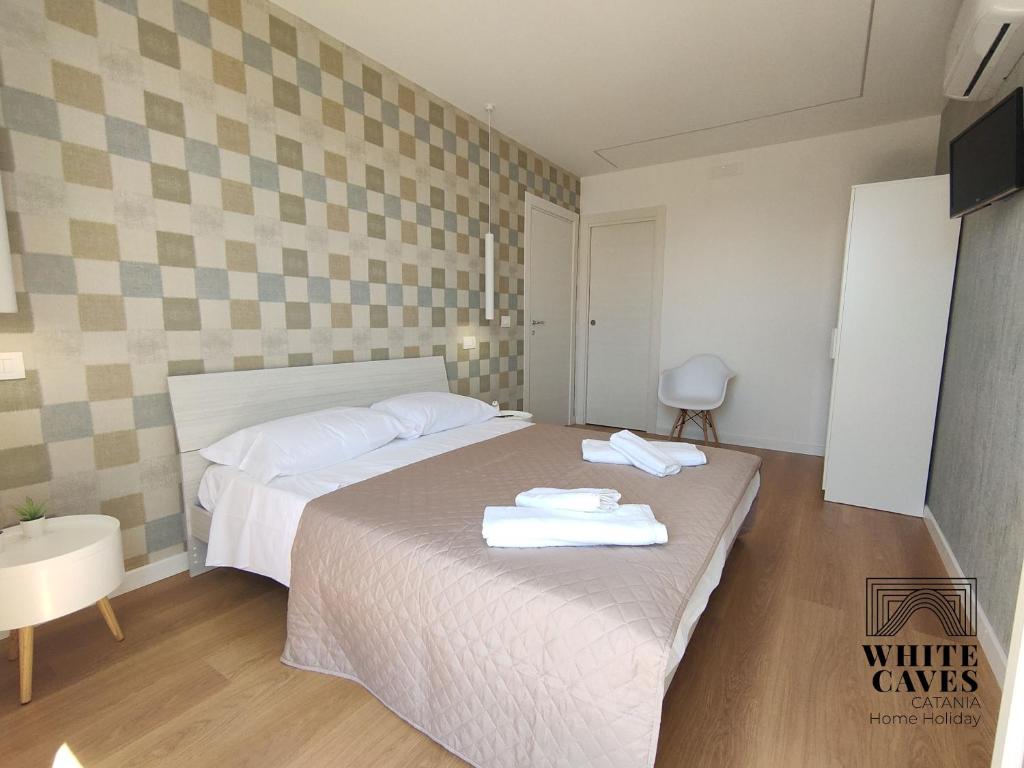 Posteľ alebo postele v izbe v ubytovaní white caves catania rooms